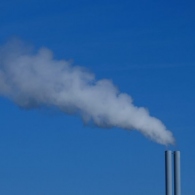 Photo of pipes releasing gas emissions into the air.